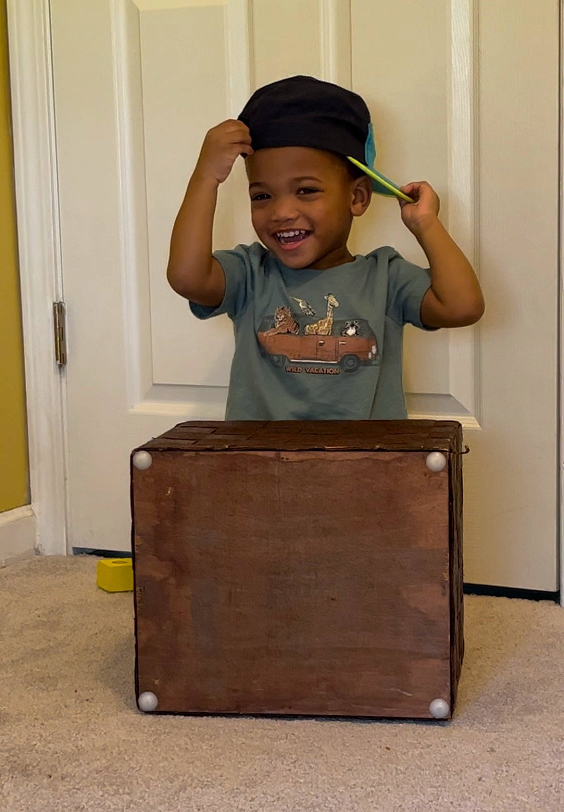 Ray Jr. is registered to the contest to win money with this photo: baby_toddler_clothing, baseball_cap, cap, chair, child, door, fun, happy, hardwood, hat, headwear, joy, person, room, sitting, sleeve, smile, t_shirt, table, toddler