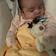 Casey is registered to the contest to win money with this photo: baby, sleeping, plush_toy, reindeer, pacifier, blanket, striped_blanket, infant, soft_toy, cozy, child, cute, resting, bedtime, clothing, indoor, person, comfort, peaceful, nursery