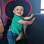 Gabin participe au concours pour gagner de l'argent avec cette photo : blue_eyes, child, clock, couch, decor, denim_shorts, face, furniture, green_shirt, hand, happy, hat, indoor, light, person, purple_wall, smiling, sombrero, toddler, window