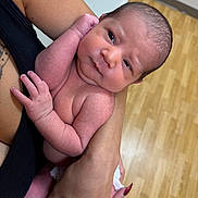Jackson is registered to the contest to win money with this photo: newborn, baby, infant, person, arm, skin, hand, nail, tattoo, floor, wood, holding, closeup, portrait, naked, human, cute, tender, care, indoor