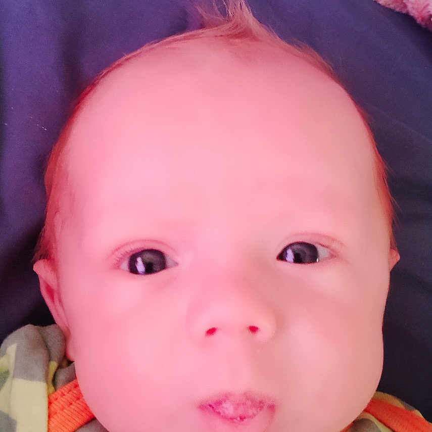 Cash Savvy is registered to the contest to win money with this photo: baby, child, close_up, clothing, cute, expression, eyes, face, green, hair, head, indoors, infant, lying_down, orange_trim, puckered_lips, skin, soft_blanket, yellow, zigzag_pattern