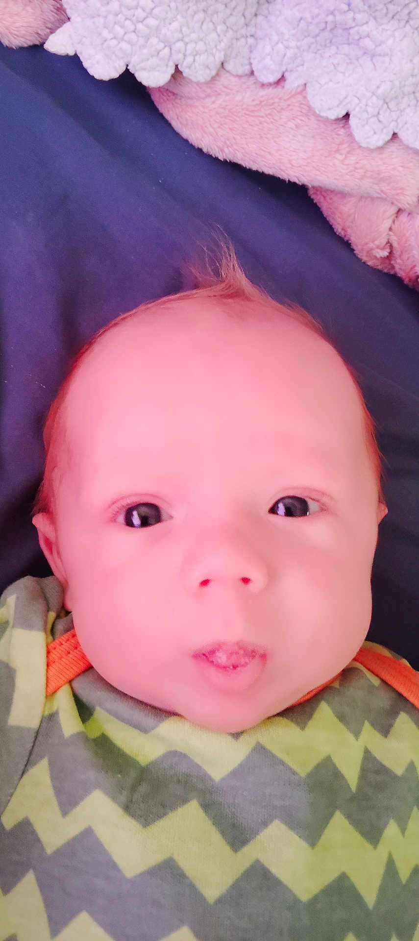 Cash Savvy is registered to the contest to win money with this photo: baby, child, close_up, clothing, cute, expression, eyes, face, green, hair, head, indoors, infant, lying_down, orange_trim, puckered_lips, skin, soft_blanket, yellow, zigzag_pattern
