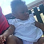 Faith is registered to the contest to win money with this photo: accessories, baby, bench, blouse, chair, clothing, cream, dessert, dress, face, furniture, grass, head, outdoors, person, photography, plant, portrait, shorts, sitting