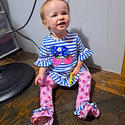 Rosa-Lee joined the competition — help win amazing prizes! toddler, child, smiling, sitting, striped_clothing, bow, pink, blue, long_sleeves, pants, patterned_pants, floor, wooden_floor, indoor, hair_bow, happy, cute, person, baby, playful