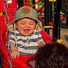 toddler, child, swing, playground, hat, striped_shirt, red, happy, laughing, outdoor, sunlight, adult, chain, play_equipment, person, smile, fun, recreation, park, joy