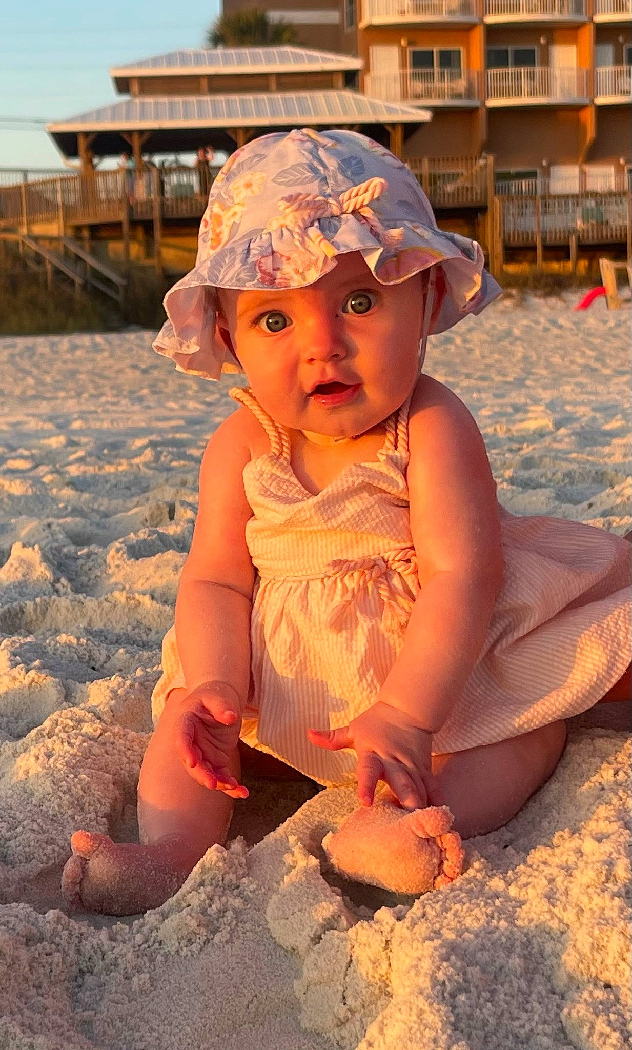 Blaire is registered to the contest to win money with this photo: baby_toddler_clothing, beach, beauty, body_of_water, cap, fun, happy, hat, headwear, light, people_in_nature, people_on_beach, person, photograph, sand, sky, snapshot, summer, sun_hat, sunlight