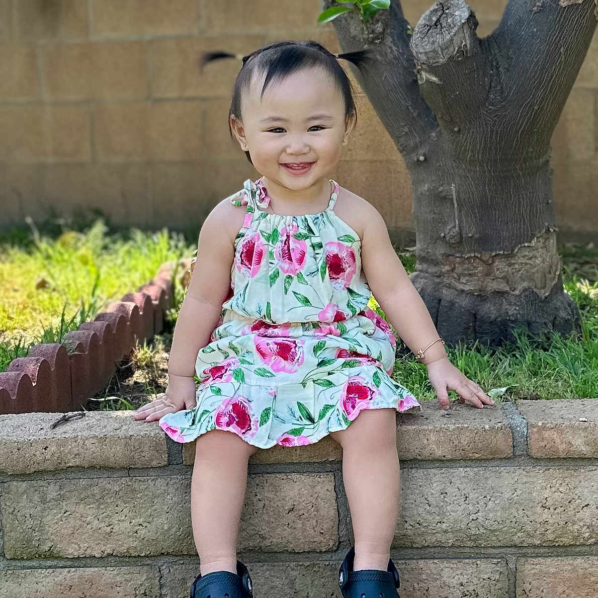 Celine Huang is registered to the contest to win money with this photo: backyard, child, clothing, dress, face, grass, head, jar, nature, outdoors, person, photography, plant, planter, portrait, pottedplant, pottery, sitting, vase, yard