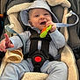 baby, infant, car_seat, teething_toy, smile, hood, onesie, seat_belt, harness, fleece, happy, stroller, buckle, hand, finger_pointing, portrait, closeup, toy, cute, child