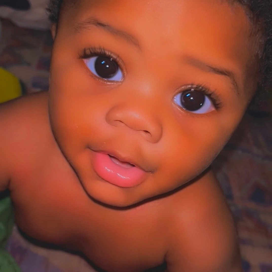 Zameer is registered to the contest to win money with this photo: adorable, baby, child, closeup, curly_hair, cute, expression, eyes, face, head, human, indoor, innocent, looking_up, person, portrait, skin, smile, soft_lighting, young