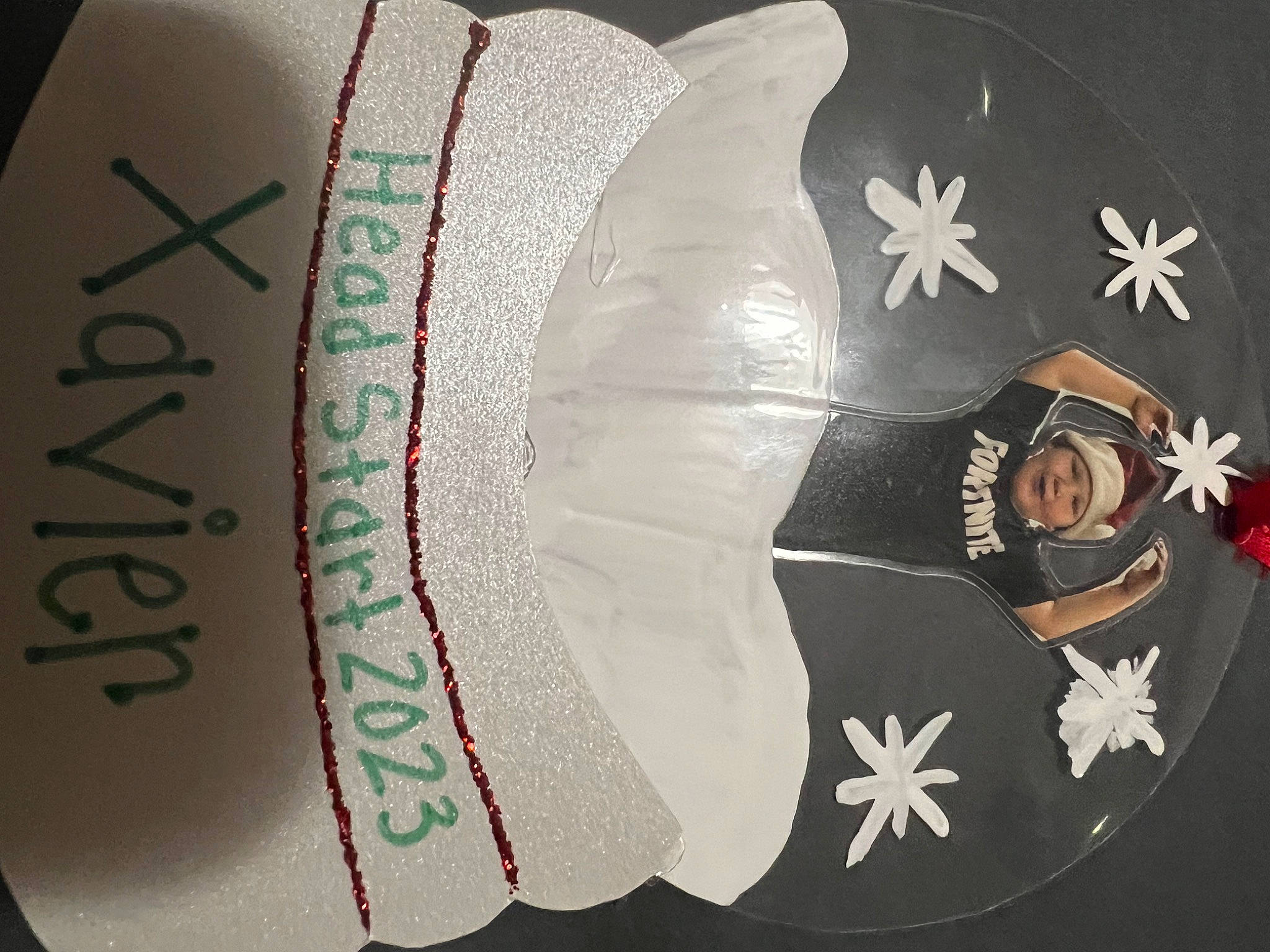 Xavier joined the competition — help win amazing prizes! brand, carmine, circle, costume_hat, crest, event, fashion_accessory, font, graphics, headwear, logo, pattern, person, sugar_cake, symbol