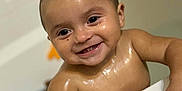 Naiomi is registered to the contest to win money with this photo: baby, child, bathtub, water, smiling, wet_skin, teeth, face, hand, bathroom, cute, infant, skin, happy, person, portrait, young_child, indoors, holding, playful
