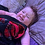 baby, smiling, blanket, plaid, bed, pillow, happy, child, toddler, face, skin, hair, hand, lying_down, cozy, indoors, cute, expression, relaxing, comfort