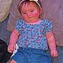 Ivy is registered to the contest to win money with this photo: baby, child, headband, couch, pillow, clothing, patterned_shirt, denim_shorts, pink_cheeks, sparkles, indoor, relaxed, cute, infant, person, smiling, shorts, sitting, soft_fabric, cozy