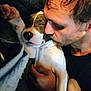 Tyson is registered to the contest to win money with this photo: man, dog, puppy, sleeping, cuddle, kiss, face, paw, hand, closeup, relaxation, indoor, warm_light, portrait, love, affection, pet, cute, rest, comfort