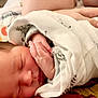 Valerie is registered to the contest to win money with this photo: newborn, baby, sleeping, blanket, zebra_print, hand, face, infant, peaceful, closeup, cushion, soft, wrapped, resting, indoors, person, cute, tiny, portrait, head