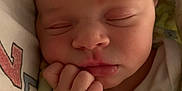 Valerie is registered to the contest to win money with this photo: baby, blanket, child, closeup, cozy, cute, face, fingers, hand, indoors, infant, newborn, peaceful, portrait, resting, skin, sleeping, soft, wrapped, young