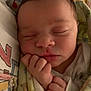 Valerie is registered to the contest to win money with this photo: baby, sleeping, newborn, blanket, infant, face, hand, cute, soft, peaceful, wrapped, closeup, child, resting, cozy, indoors, young, portrait, skin, fingers