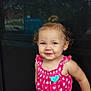 baby, child, curly_hair, cute, door, earrings, expression, fashion, hair_tie, happy, outdoor, person, pink_clothing, playful, portrait, romper, smile, standing, toddler, young_child