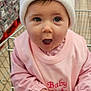 Maddison joined the competition — help win amazing prizes! baby, child, shopping_cart, hat, pink_clothing, pom_pom, face, hands, expression, grocery_store, retail, infant, cute, indoor, person, apparel, winter_wear, holding, seat, curious