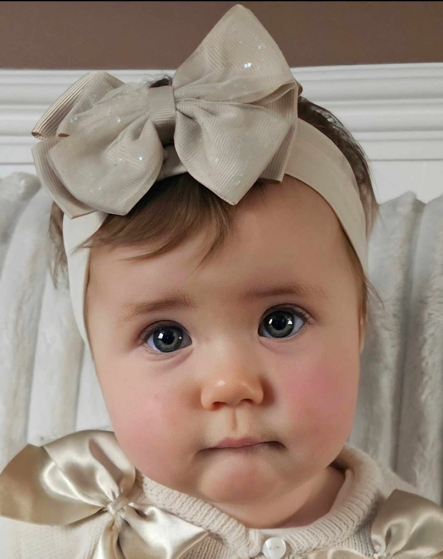 Maddison is registered to the contest to win money with this photo: baby, child, face, headband, bow, portrait, closeup, cute, infant, clothing, cream_color, soft_lighting, indoors, person, young_child, expressionless, apparel, headwear, baby_girl, adorable