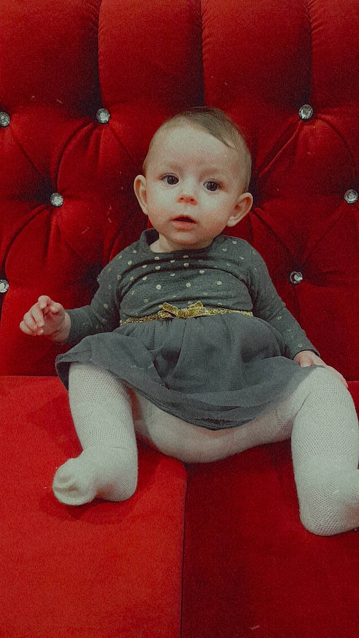 Arianna joined the competition — help win amazing prizes! baby, baby_toddler_clothing, carmine, cheek, chin, comfort, eye, flooring, fun, hair, head, human_body, iris, lap, lip, nose, person, sitting, sleeve, toddler