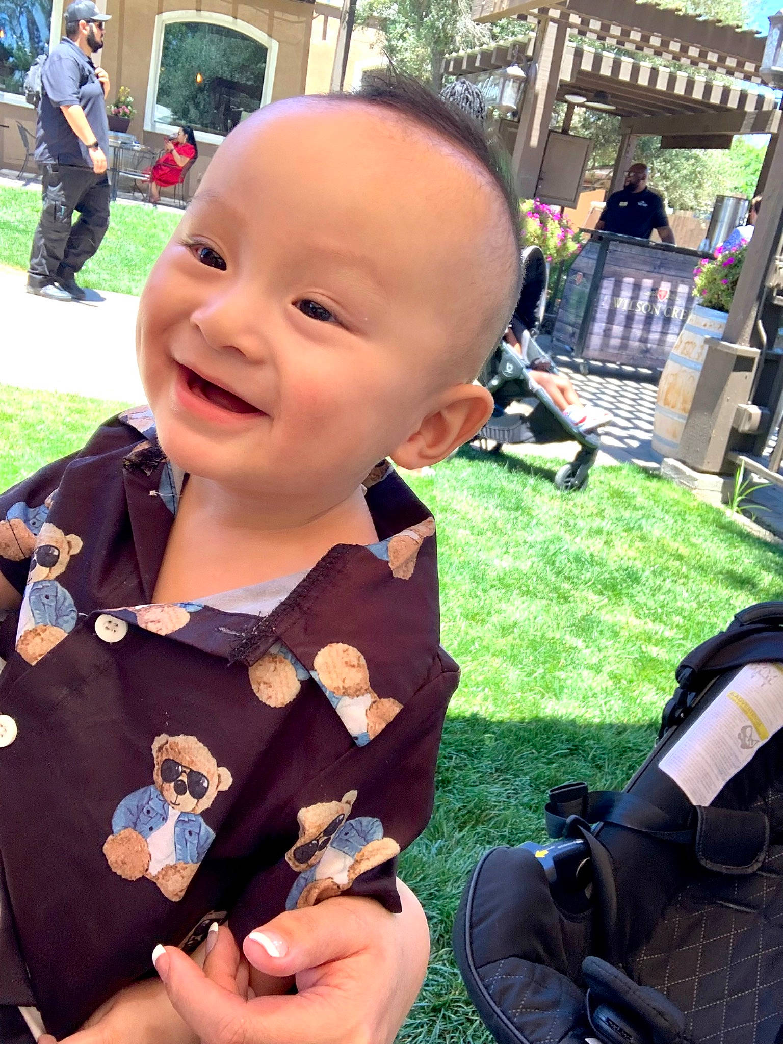 Leon is registered to the contest to win money with this photo: baby, baby_toddler_clothing, child, cool, event, fun, grass, happy, headwear, joy, leisure, luggage_and_bags, person, plant, recreation, shorts, sitting, skin, smile, summer