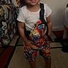 barefoot, bucket_hat, carpet, casual, child, colorful_clothing, couch, cute, furniture, happy, home, indoor, person, portrait, shorts, smiling, standing, toddler, white_tshirt, young_child