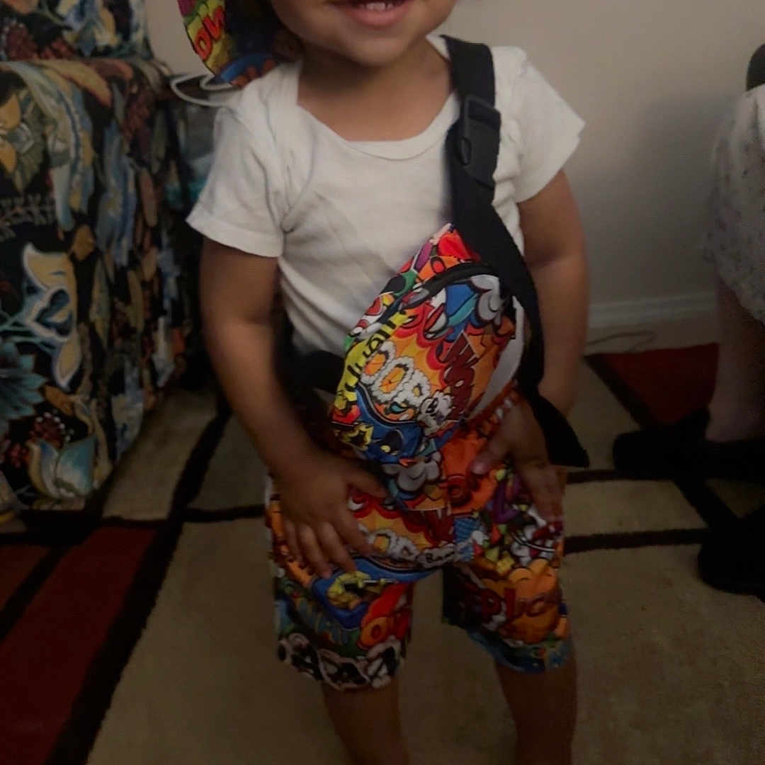 Amaro joined the competition — help win amazing prizes! barefoot, bucket_hat, carpet, casual, child, colorful_clothing, couch, cute, furniture, happy, home, indoor, person, portrait, shorts, smiling, standing, toddler, white_tshirt, young_child