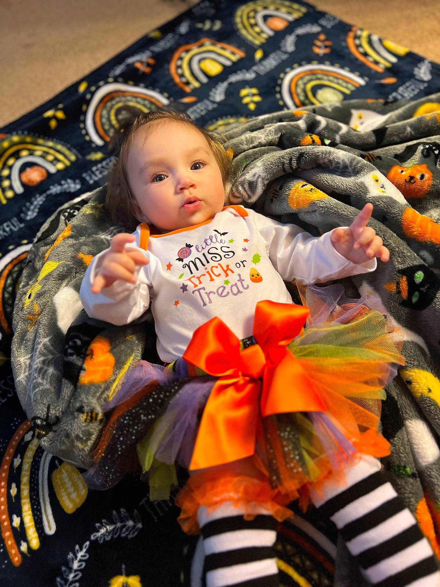 Katalina is registered to the contest to win money with this photo: baby, baby_carriage, baby_products, baby_toddler_clothing, child, event, flooring, fun, happy, linens, orange, pattern, people, person, room, sitting, toddler