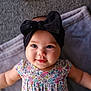 Ava Angeline is registered to the contest to win money with this photo: baby, child, headband, black_bow, smile, floral_dress, blanket, lying_down, skin, face, arm, indoors, happy, cute, portrait, infant, soft, closeup, head, eyes