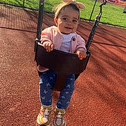 Kazora joined the competition — help win amazing prizes! child, toddler, swing, playground, headband, bow, pink_cardigan, jeans, butterfly_print, sneakers, outdoor, sunny, smiling, happy, chain_link_fence, grass, play_area, baby, fun, daytime