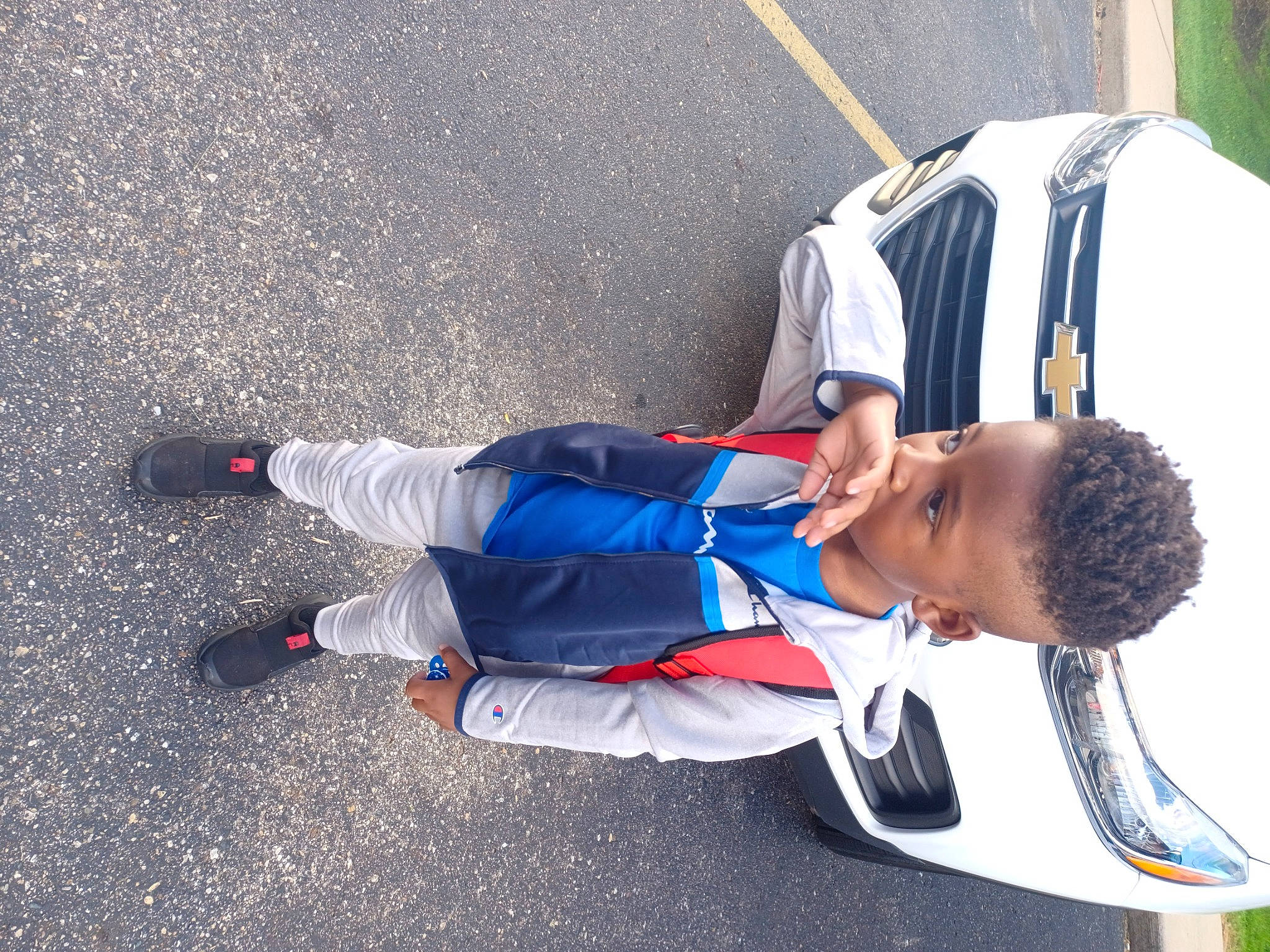 Za'Mir is registered to the contest to win money with this photo: asphalt, backpack, carmine, concrete, elbow, electric_blue, fun, knee, leisure, outdoor_shoe, pedestrian, person, recreation, road_surface, shadow, sitting, sneakers, sportswear, t_shirt, toddler