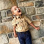 Xaviar is registered to the contest to win money with this photo: architecture, boy, building, child, clothing, face, flagstone, happy, head, jeans, laughing, male, pants, path, person, photography, portrait, rock, walkway, wall