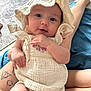 Everly joined the competition — help win amazing prizes! baby, infant, clothing, bonnet, tattoo, legs, blanket, person, cute, smiling, portrait, indoor, fabric, closeup, skin, hand, sitting, child, face, soft