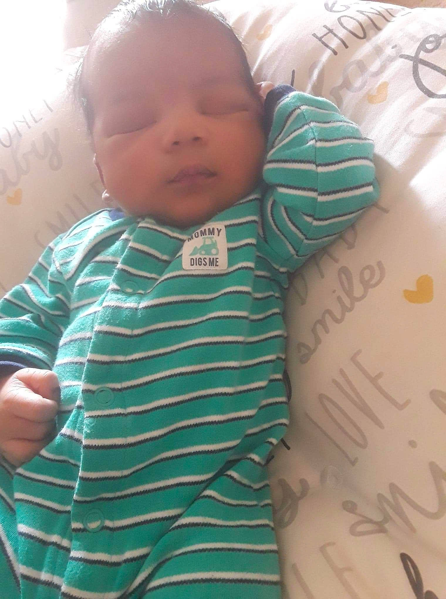 Ethan-allen is registered to the contest to win money with this photo: baby, baby_toddler_clothing, cheek, child, face, forehead, green, head, nose, person, skin, sleeve, toddler