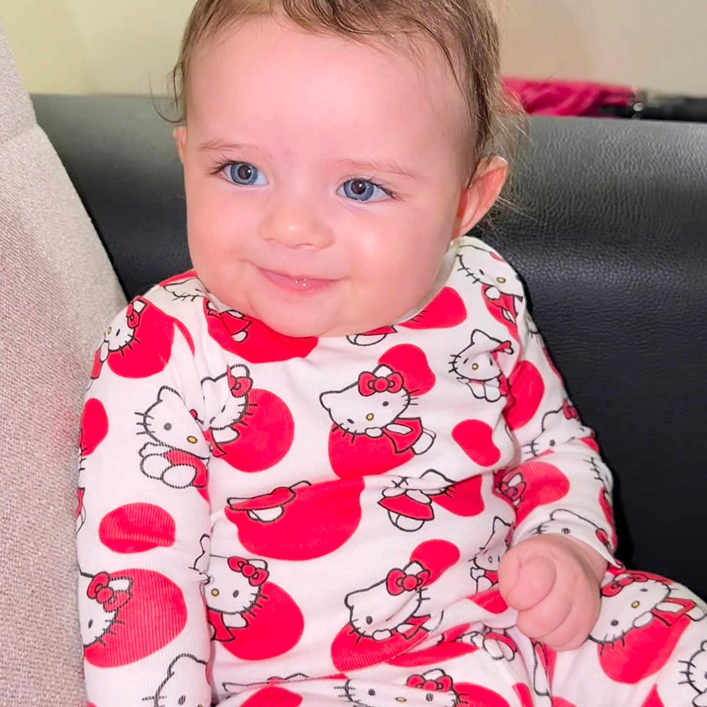 Bithiah is registered to the contest to win money with this photo: baby, child, smile, blue_eyes, hello_kitty, pajamas, red_hearts, cute, sitting, couch, cozy, indoors, clothing, portrait, infant, happy, soft_lighting, face, hair, skin