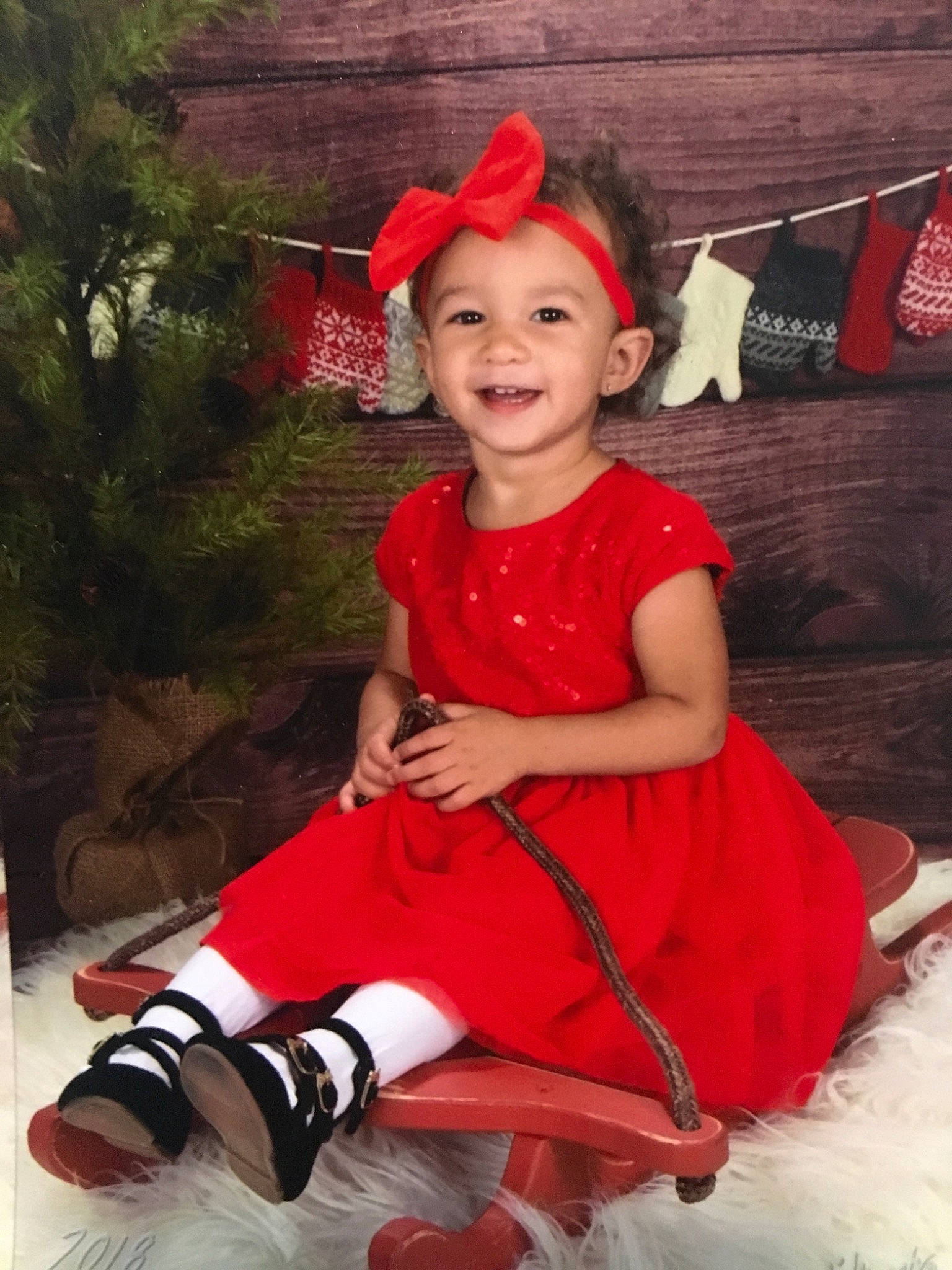 Audrianna is registered to the contest to win money with this photo: child, christmas, costume, day, fun, girl, hair_accessory, happiness, headgear, holiday, joy, person, product, red, skin, smile, toddler