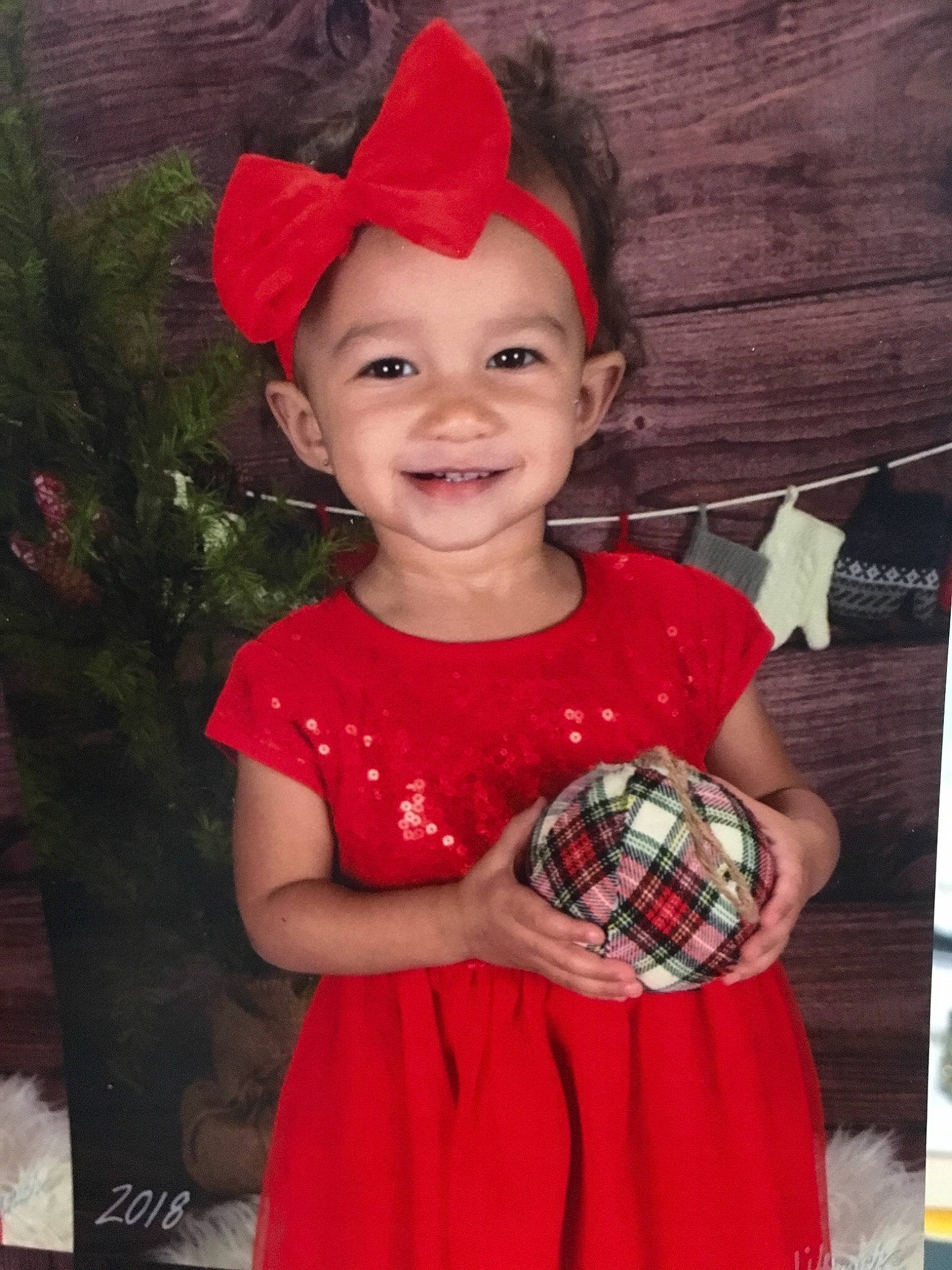 Audrianna is registered to the contest to win money with this photo: christmas, costume, day, girl, hair_accessory, headgear, holiday, joy, pattern, person, product, red, smile, tartan, toddler