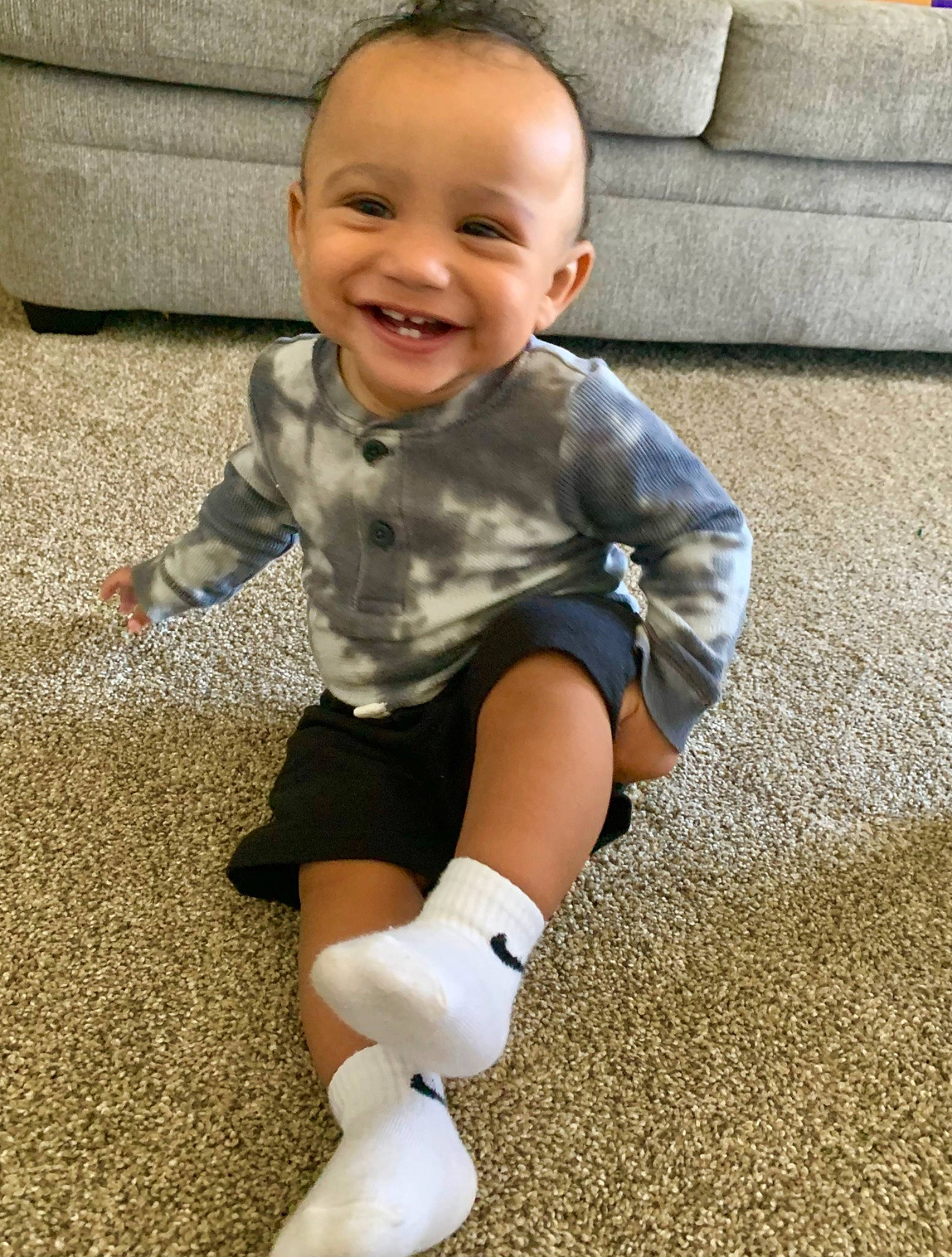 Jayceon is registered to the contest to win money with this photo: arm, baby, baby_toddler_clothing, child, clothing, couch, finger, flooring, grass, happy, human_body, human_leg, joy, knee, people, person, skin, sleeve, smile, sock