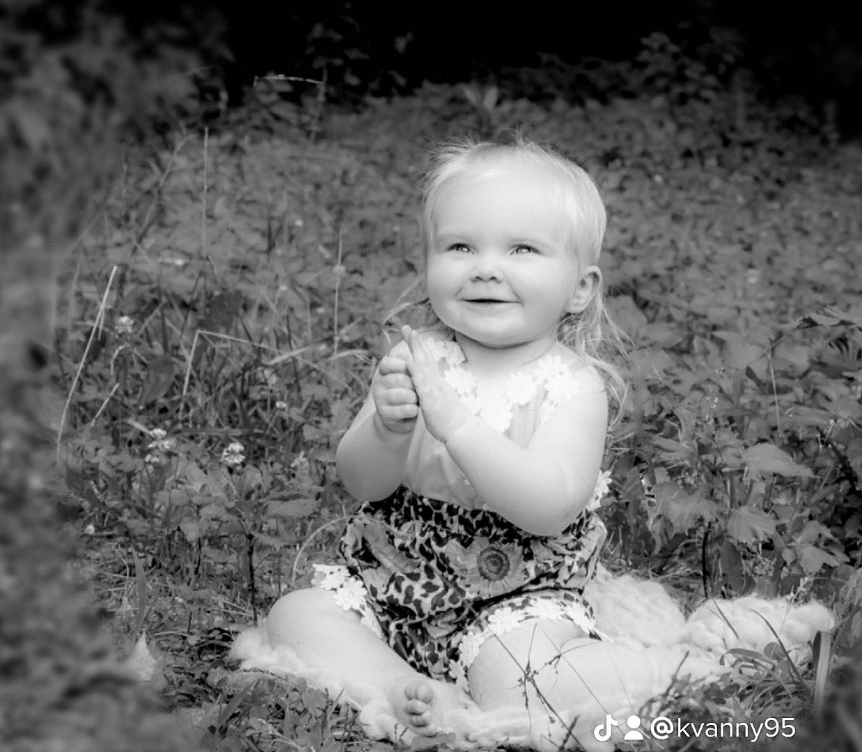 Lena joined the competition — help win amazing prizes! baby, baby_toddler_clothing, black_and_white, cheek, child, dress, face, flash_photography, grass, happy, joy, monochrome, monochrome_photography, people_in_nature, person, plant, sitting, skin, smile, toddler