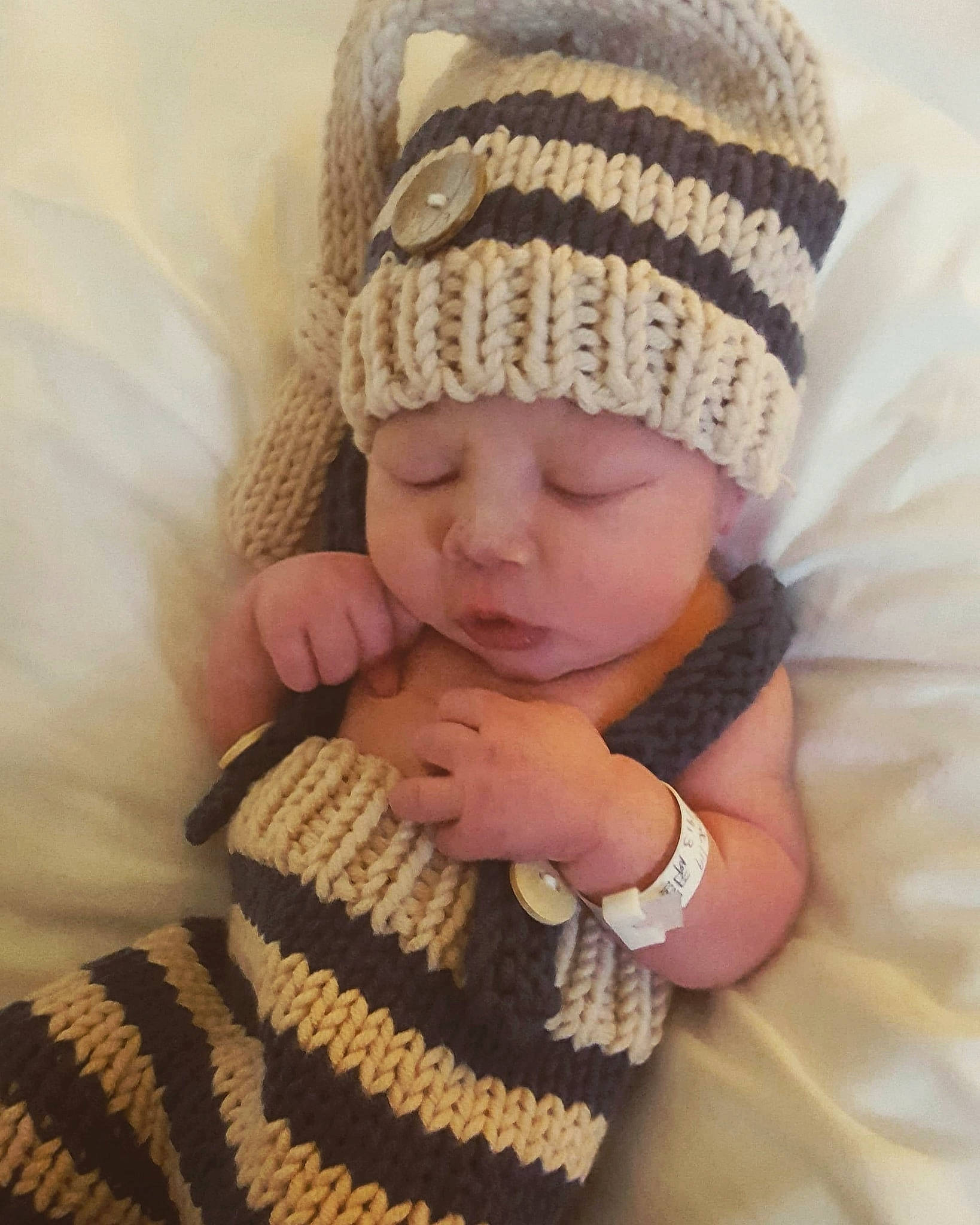 Lincoln joined the competition — help win amazing prizes! baby, beanie, bonnet, cap, child, crochet, fashion_accessory, finger, hand, hat, headgear, headwear, knit_cap, knitting, person, skin, toddler, wool