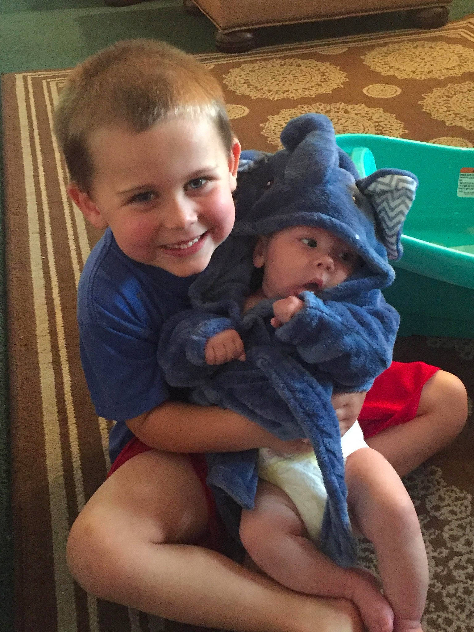 Blaze is registered to the contest to win money with this photo: arm, cheek, child, finger, fun, joy, lap, leg, person, sitting, skin, smile, thigh, thumb, toddler