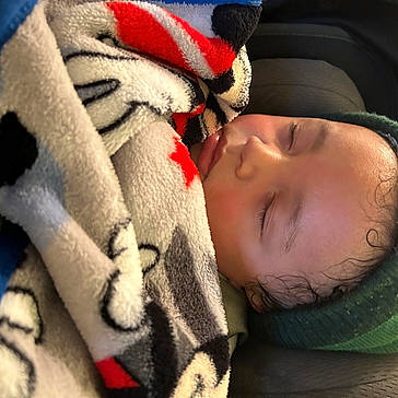 Giovanni is registered to the contest to win money with this photo: baby, baby_sleeping, bedtime, cap, carmine, cheek, child, close_up, comfort, eye, eyelash, fur, knit_cap, linens, nose, person, skin, textile, toddler, tree