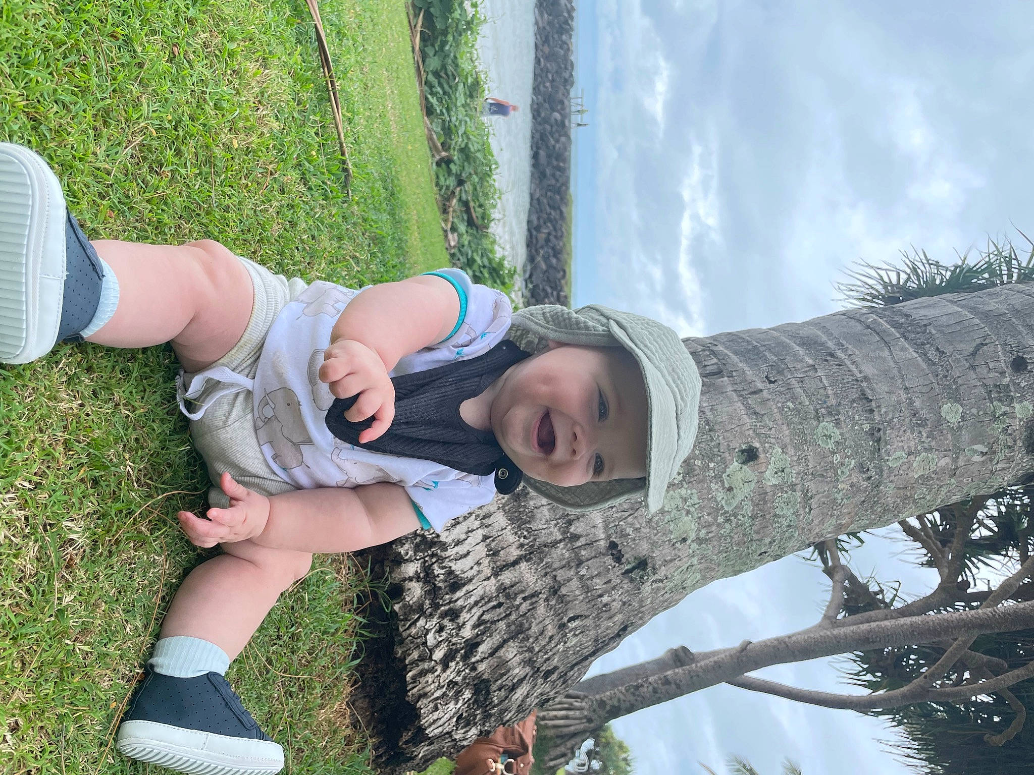 Oaklee is registered to the contest to win money with this photo: baby, cloud, foot, fun, grass, happy, headwear, human_leg, joy, knee, leisure, people_in_nature, person, plant, recreation, sandal, shorts, sky, sock, thigh