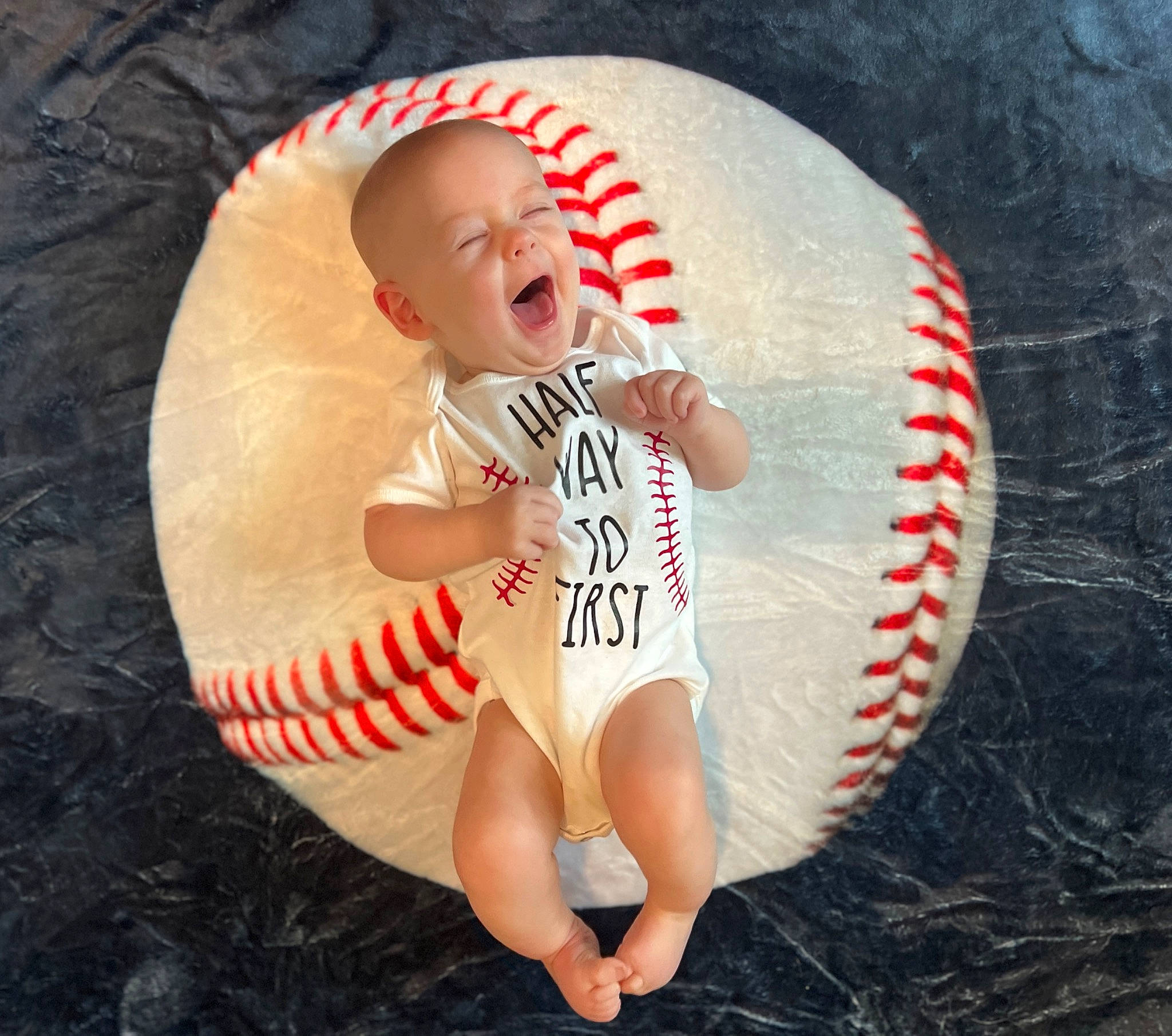 Colt is registered to the contest to win money with this photo: baby, baby_sleeping, baby_toddler_clothing, ball, baseball, carmine, child, flash_photography, foot, football, happy, human_leg, person, personal_protective_equipment, sports_equipment, sports_gear, swimwear, team_sport, thigh, thumb