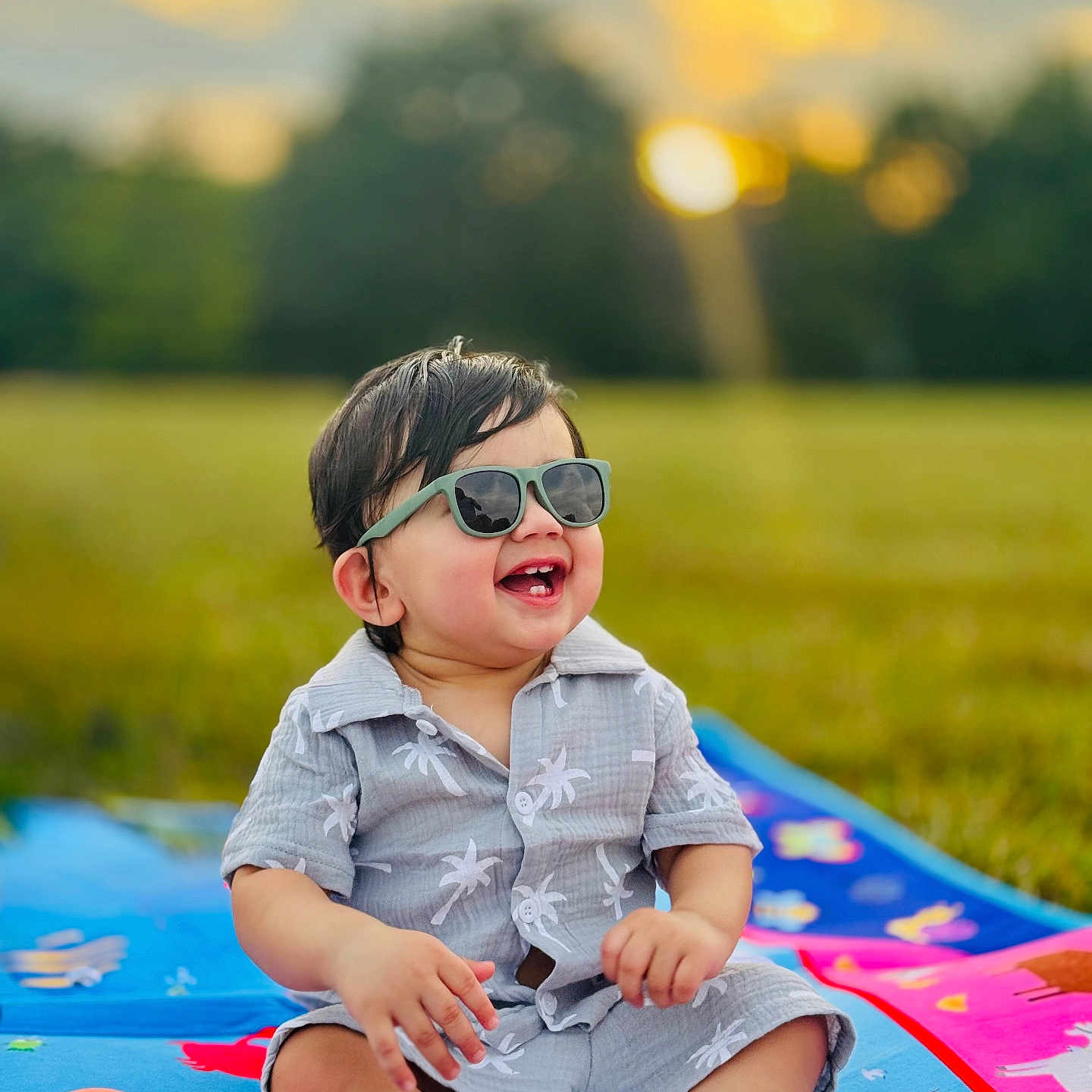 Arshan joined the competition — help win amazing prizes! baby, blanket, casual, child, cute, daylight, field, fun, grass, happy, nature, outdoor, playful, portrait, sitting, smiling, summer_clothing, sunglasses, sunset, toddler