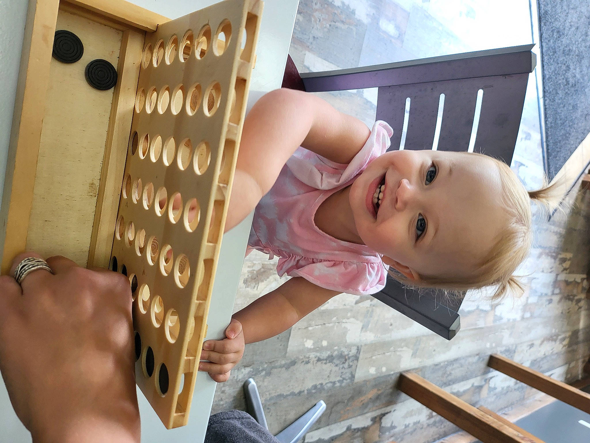 Emmy is registered to the contest to win money with this photo: baby, baby_products, cardboard, child, eyewear, finger, flooring, fun, gesture, happy, joy, person, product, room, smile, toddler, wood