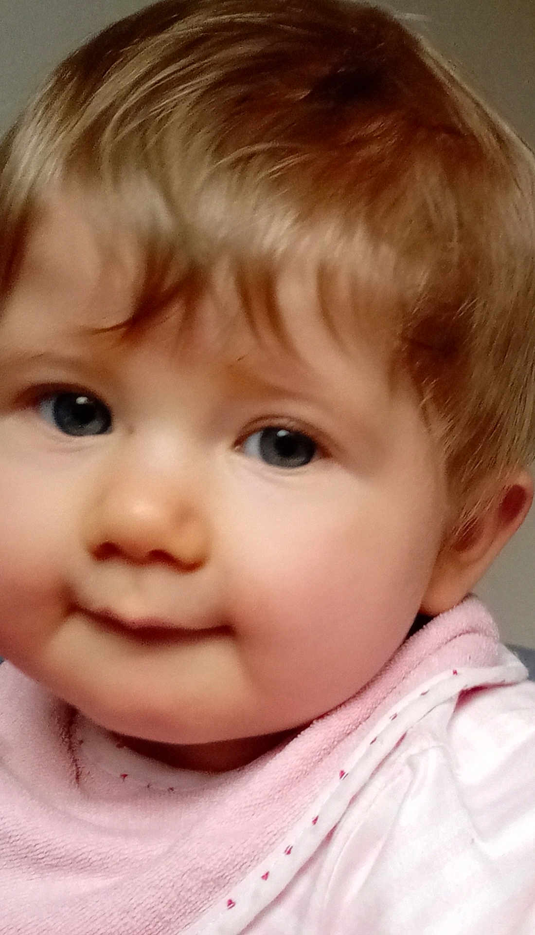 Adele a rejoint le concours — aidez-le/la à gagner de superbes lots ! baby, child, face, closeup, blue_eyes, pink_bib, soft_hair, chubby_cheeks, cute, portrait, infant, young_child, smile, skin, clothing, person, indoor, expression, adorable, head