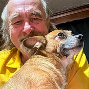 Pistol Pete joined the competition — help win amazing prizes! adult, animal, closeup, companionship, cuddle, dog, expression, face, friendship, fur, hair, happy, head, indoor, man, person, pet, portrait, smile, yellow_shirt
