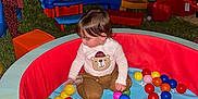 Ezequiel Cortinez joined the competition — help win amazing prizes! child, toddler, ball_pit, slide, outdoor, playground, night, string_lights, grass, toy, colorful, red_slide, blue_toy, brown_pants, bear_shirt, playing, multicolored_balls, person, fun, recreation
